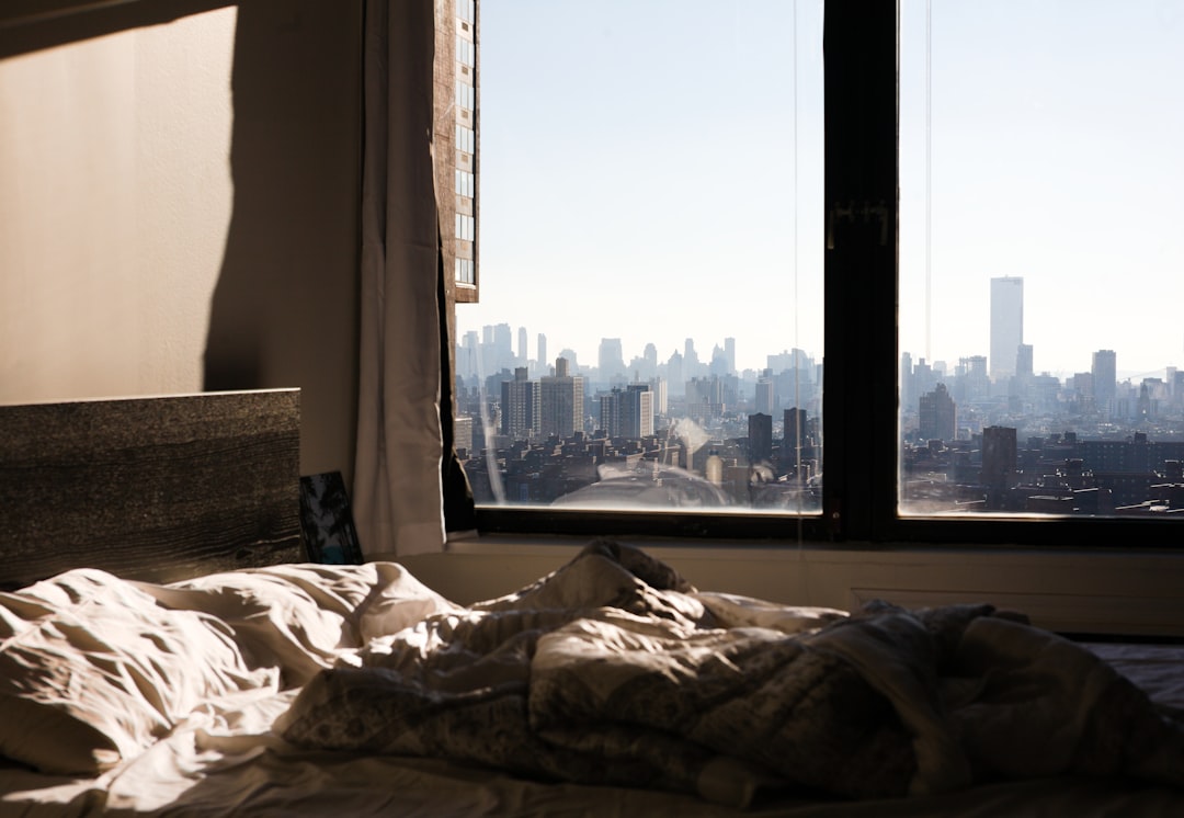 a-view-of-a-city-from-a-bedroom-window-r2qs28o3swa