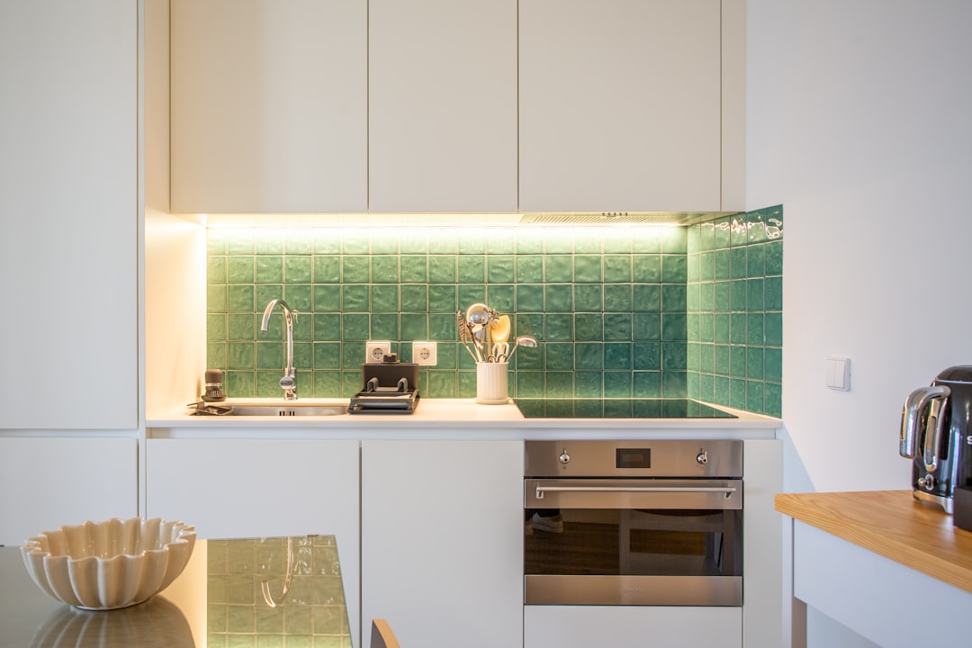a-kitchen-with-a-sink-stove-microwave-and-toaster-oven-kug5llnutbo